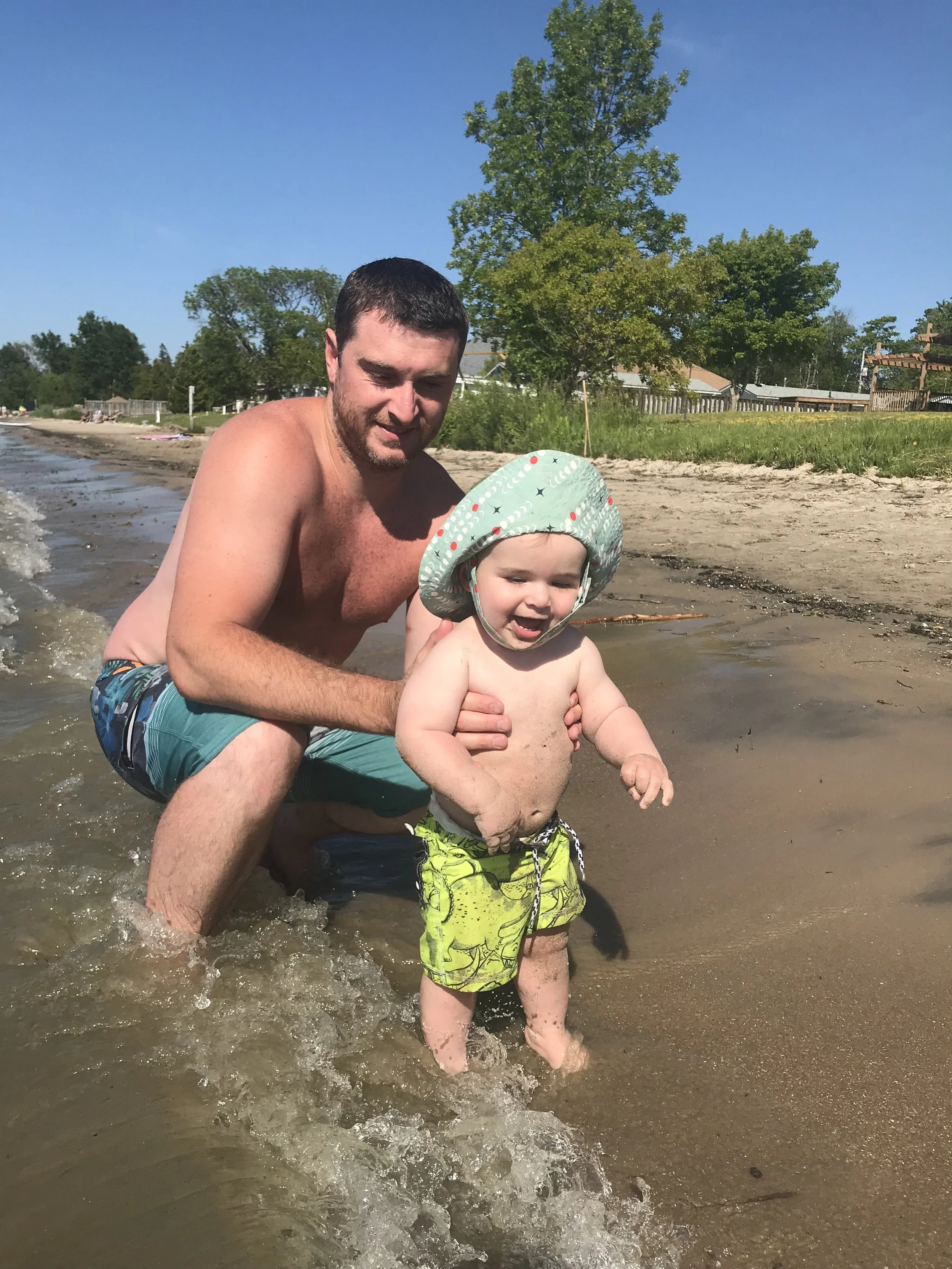  Loving playing in the little waves…except while sitting. One hit my back and startled me! Standing in them with dad is much better. 