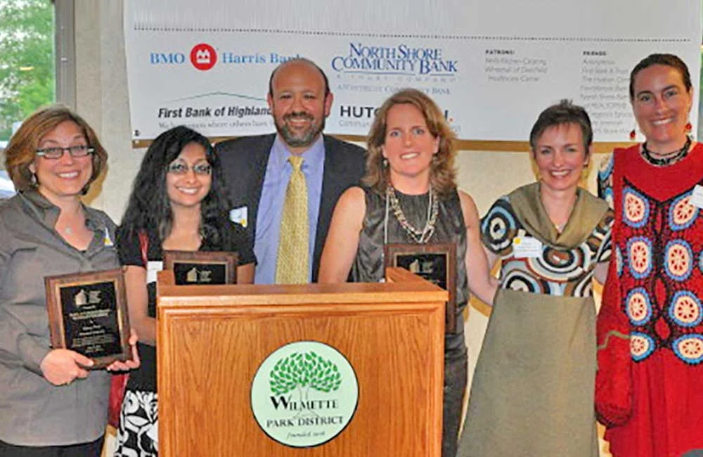 (2011 - 2012) Winnetka Is Neighborly wins the 2012 Rayna & Marvin Miller Housing Justice Award from Open Communities. In addition to the Property Maintenance Code victory for renters, WIN also helped gain passage of a coach house ordinance, allowing 30 homeowners to turn their coach houses into rentals if they so choose. Left to right: Nancy Pred, Surrosh Shakir, Mark Miller (presenting the award), Ann Airey, Katie Seigenthaler, and Jen McQuet.