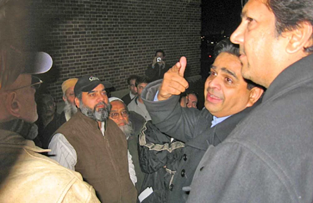 (2007 - 2008) Skokie taxicab drivers celebrate outside the Village Hall after the Trustees unanimously voted to put on hold the implementation of a parking ban and work with drivers.