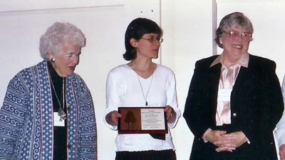 On behalf of MUM, Jean Cleland, Gail Schechter, and Mimi Ryan accept a Golden Trowel Award in Springfield from Housing Action Illinois.