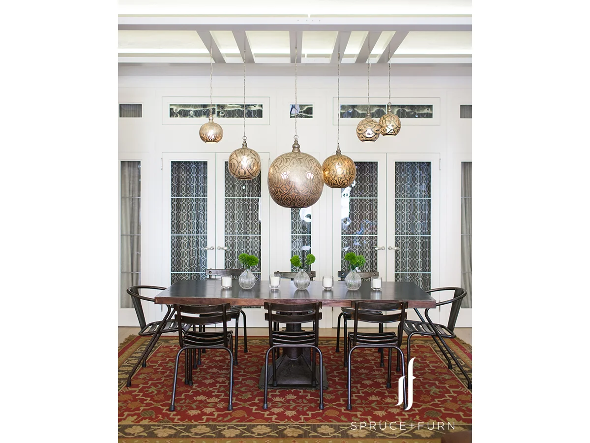 A group of ornate Moroccan chandeliers hanging above the table distinctly identifies the dining area. Photo credit: Steph Goralnick www.sgoralnick.com 