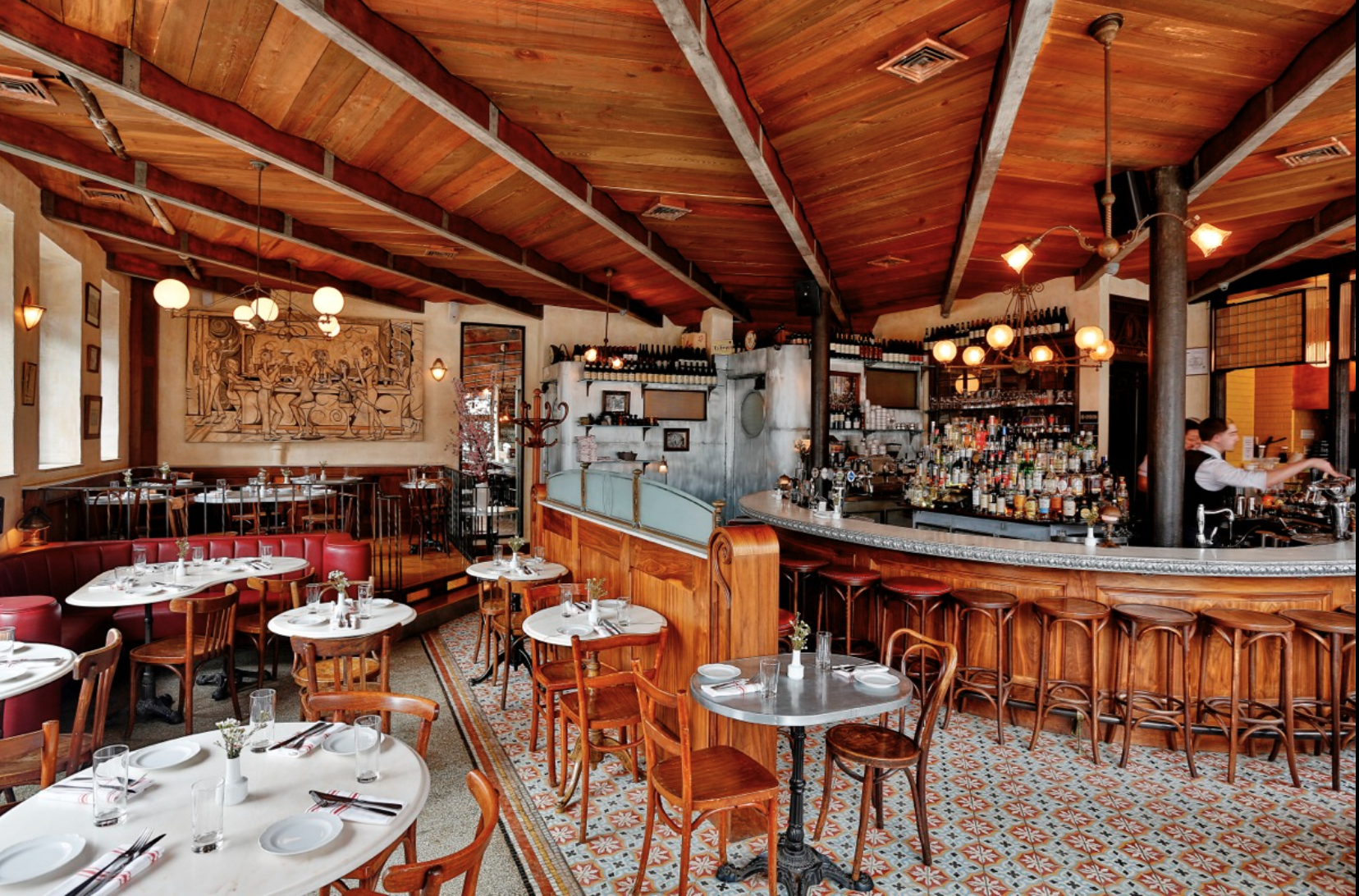 This is an inspiration shot of a restaurant in Williamsburg, Brooklyn that mixes floor tiles and features raised wood floor areas and upholstered (short) banquettes. The tone of the wood is different but it gives a sense of how a more colorful tile plays in the space. Source: http://www.witlofnyc.com/galleries/restaurant