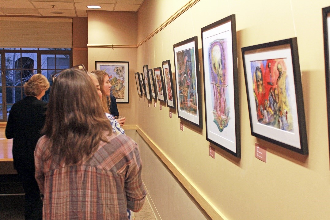 Guests enjoy the work of artist Jim Hill