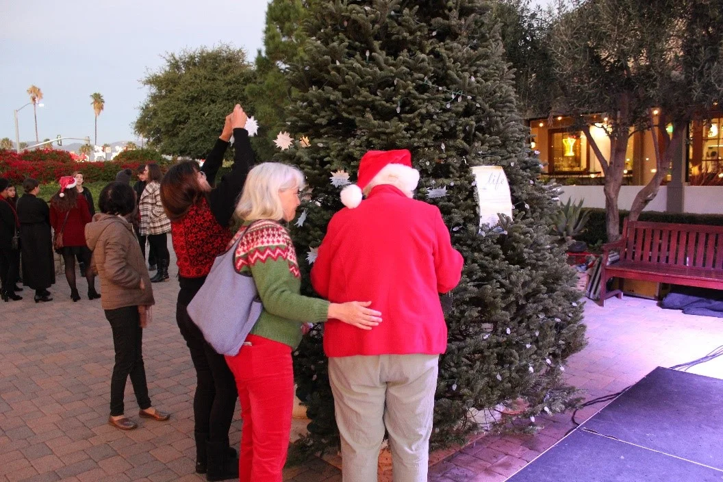 Community members hang stars in remembrance of loved ones during Light Up A Life.