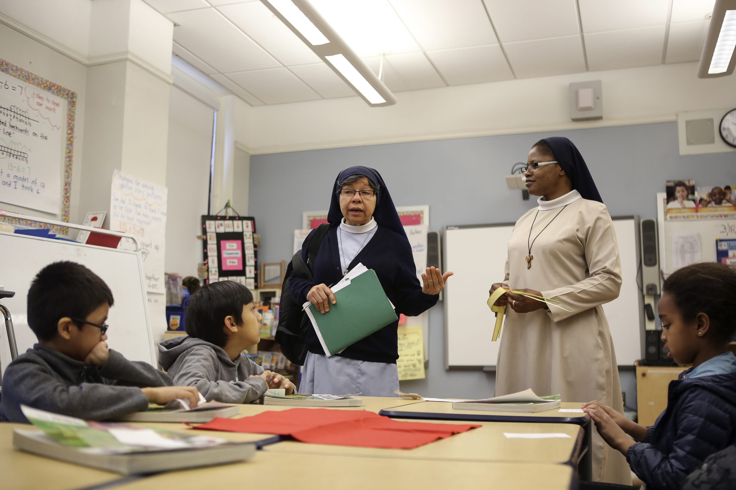 Sister Mary Ann Baichan and Sister Mary teach Sunday school to children after mass at the Church of St. Joseph of the Holy Family.