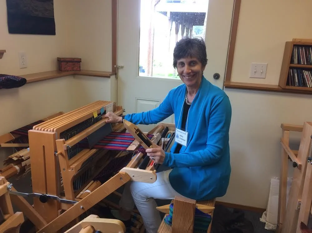 Me sitting at one of the 8-harness, Baby Wolf Schacht looms.