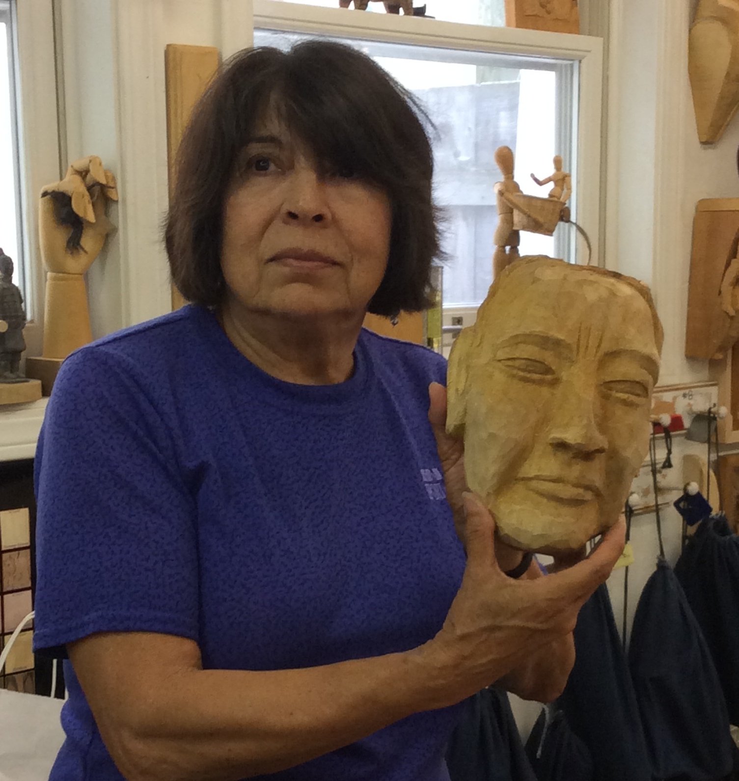 Elena is finishing up her female Native American mask as a companion piece to her male mask from a previous Balinese Mask carving workshop. 