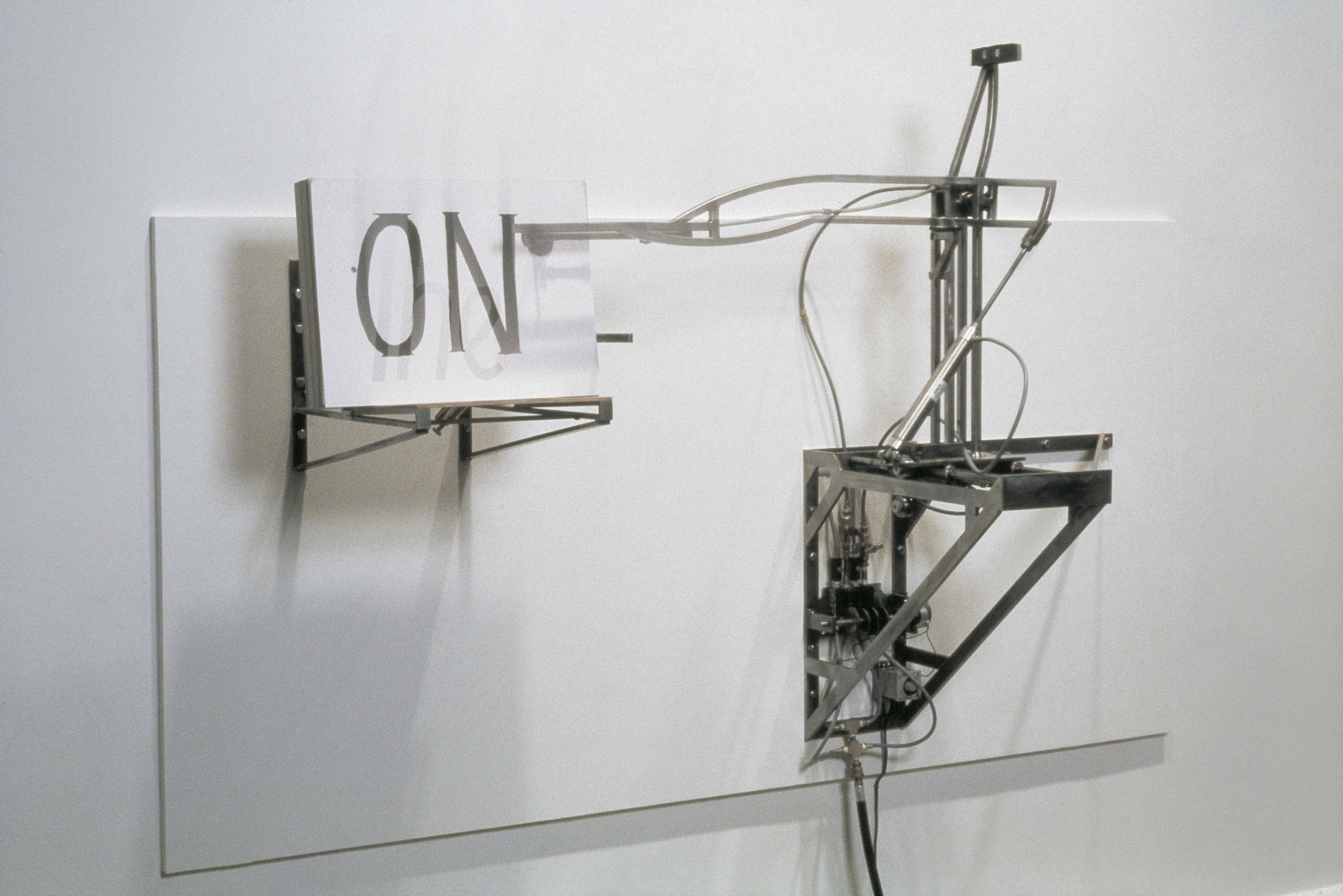  Placard Flinger, 1995, Steel, pneumatics, rubber, motor, and ink on cardboard, 48 x 60 x 24 inches 