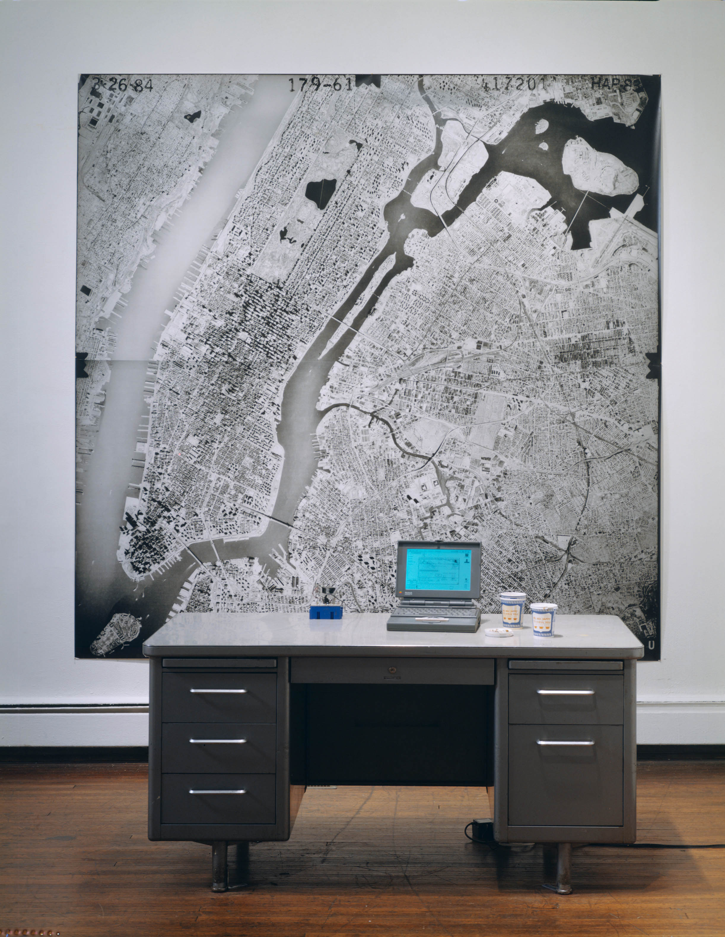  Where I'm At, 1993-1995, Black-and-white photograph, desk, computer with laser pointer, GPS unit, and cellular phone, 96 x 96 x 54 inches 