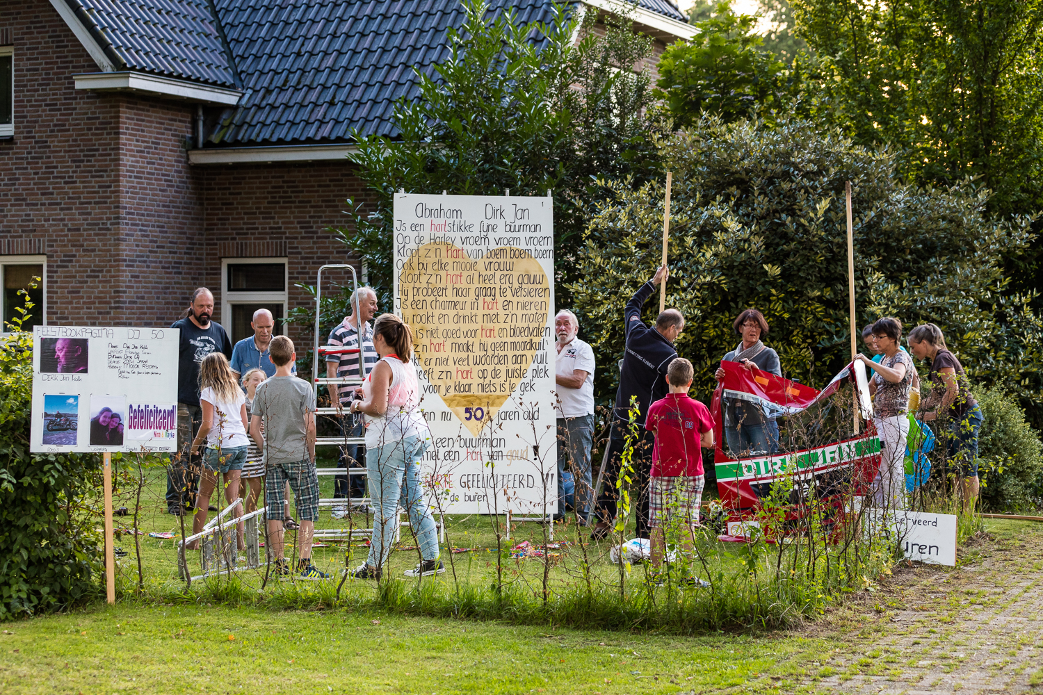 De buren in de weer met de traditionele versieringen.