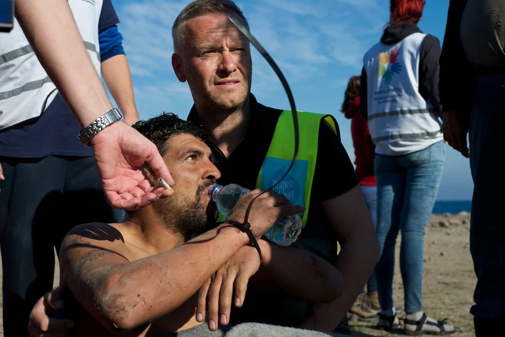  Volunteers restrain a Turkish man ferrying migrants to Lesvos, Greece, 2015. 