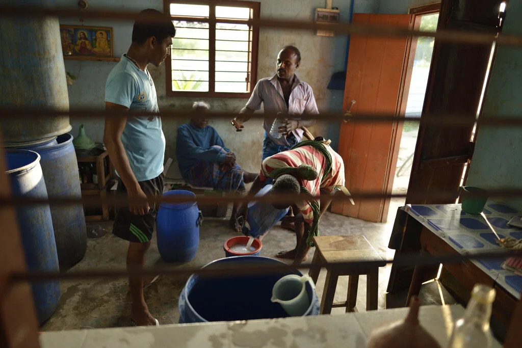 Toddy tappers - victims of both caste and government discrimination - at a tavern outside Jaffna, Sri Lanka, 2018