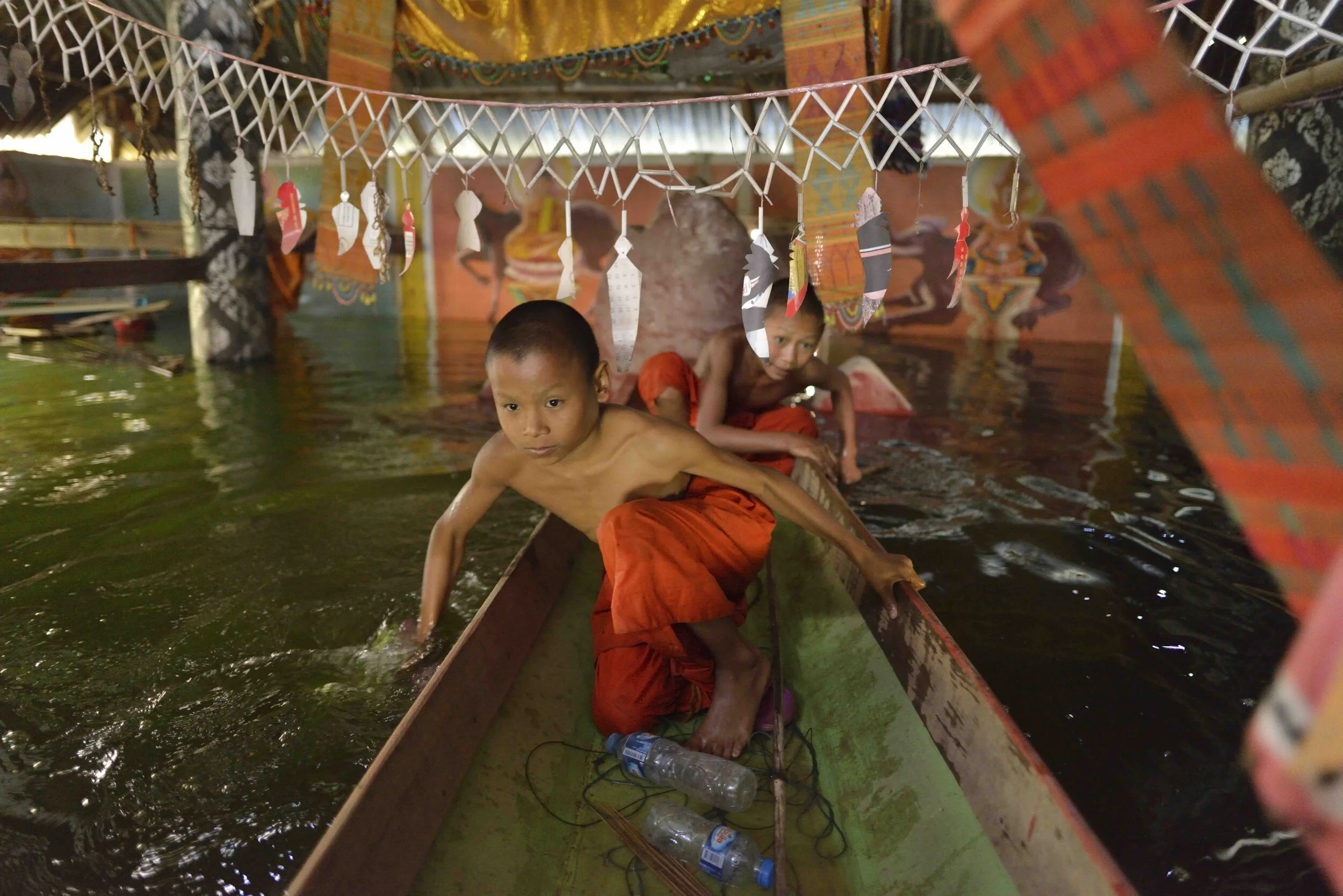  Novice Buddhist monks in a temple being submerged by the Chinese-built Nam Ou 1 dam, Laos, 2019. 