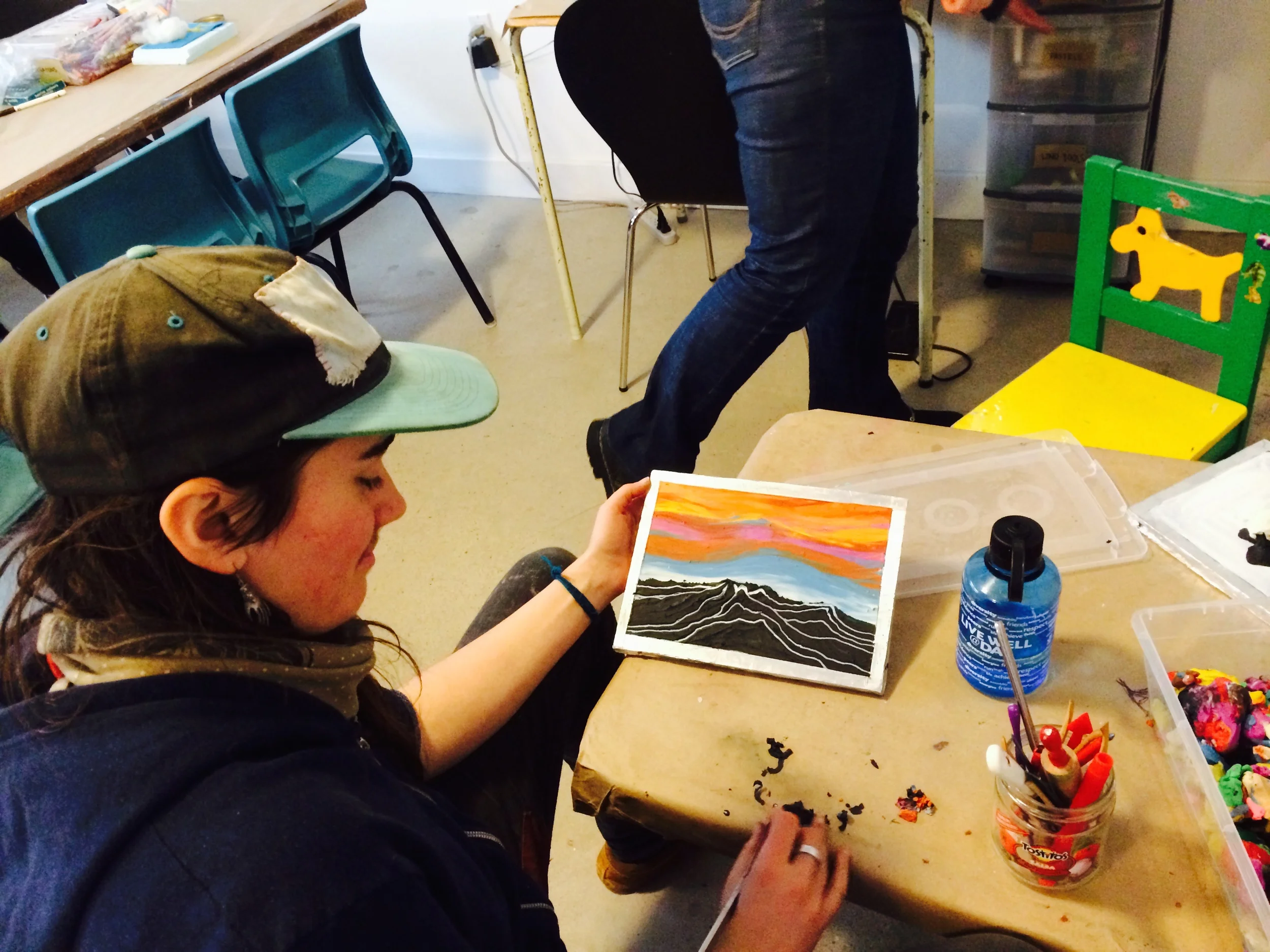 Our facilitator, Jeighk, at work on a plasticine picture - by blending the colours and carving out lines, she's made gorgeous art!