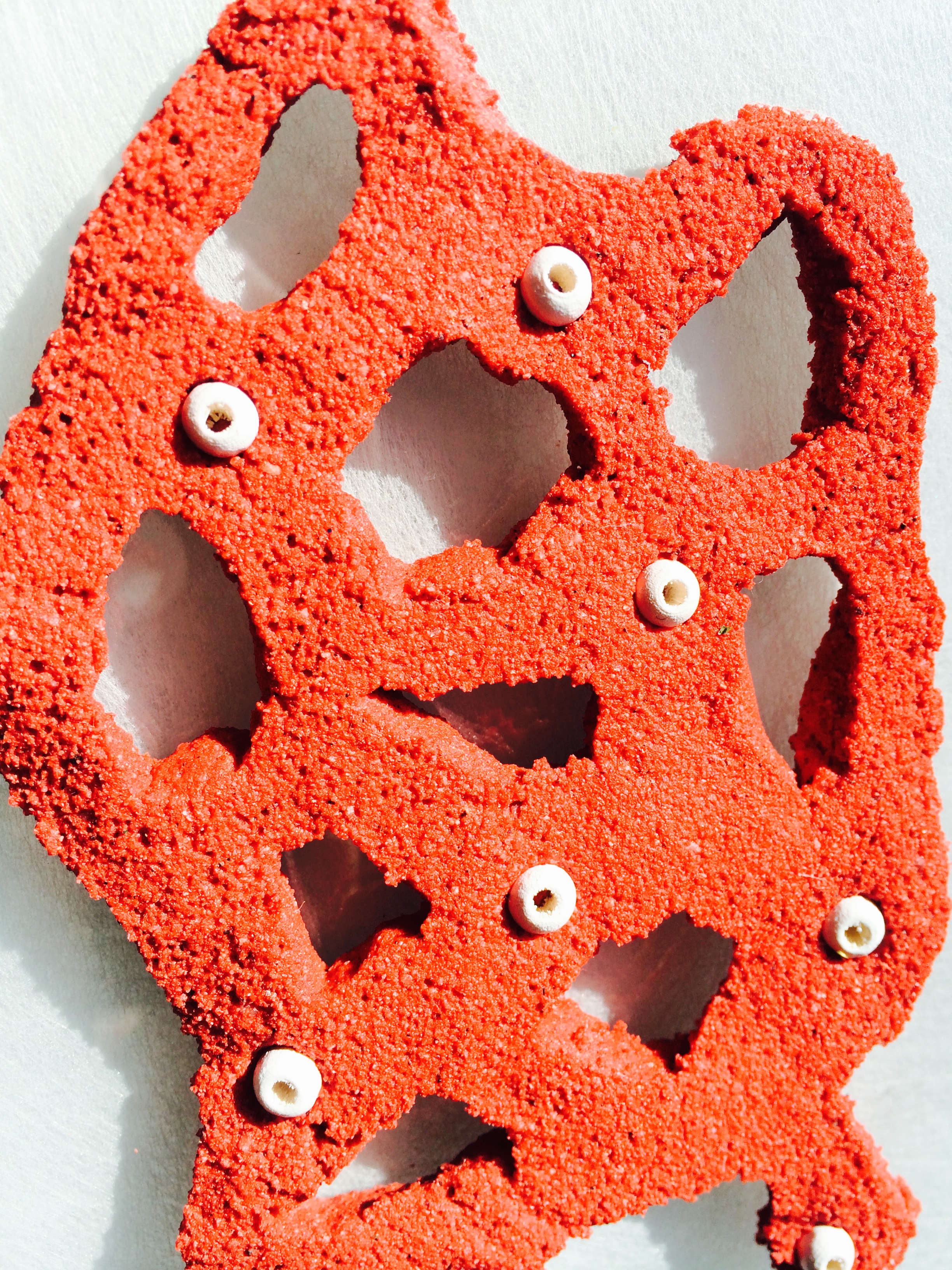 A mixture of white glue, acrylic paint, and SAND for a sculpture medium that hardens after about a day.