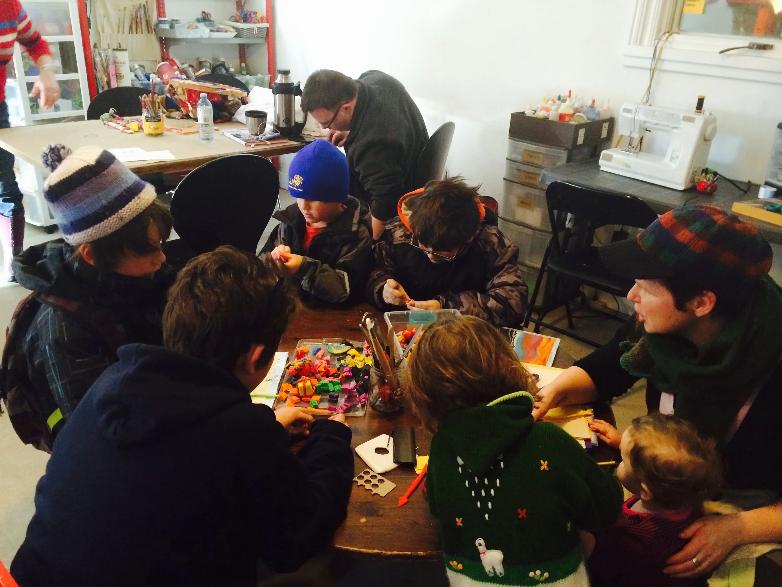 After school independent crowd mixed with preschoolers from the area - all busy at the kids' table with plasticine.