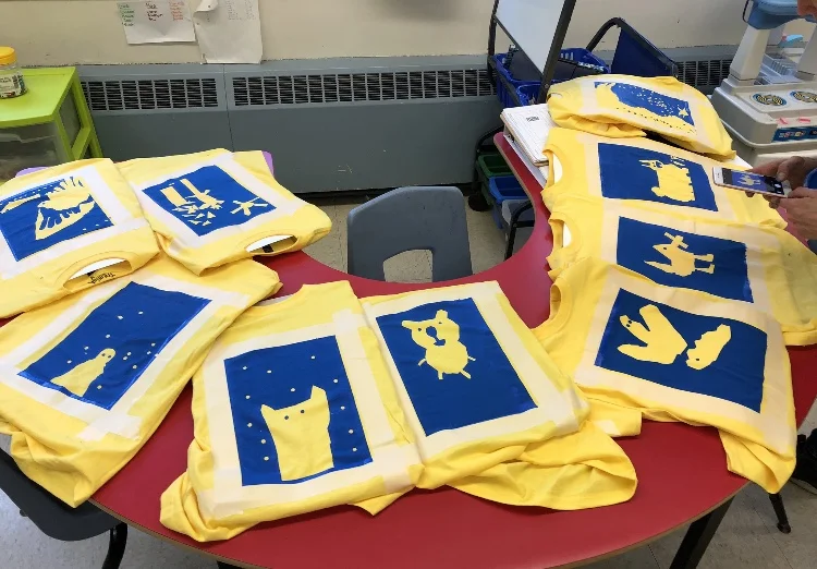 Shirts designed and silkscreened by Mme Swinamer’s Grade 1 class at Ecole St Joseph’s A McKay! We have an annual tradition of exploring geometric shapes to create unique t-shirt designs with all the grade 1 students at the school. And it’s such a highlight to see kids around the neighbour hood in their distinctive school colours! Photo credit: Mme Swinamer from Twitter @MmeSwinamer