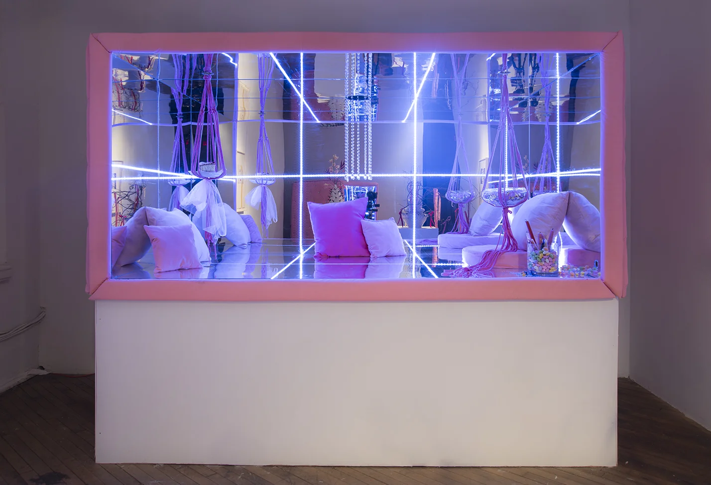   The Lounge   Mirrored acrylic, wood, LED strips, velvet, rhinestone buttons, handmade pillows, glass dishes, assorted candies, candles, cake, macrame hangers  7’x8’x4’ 