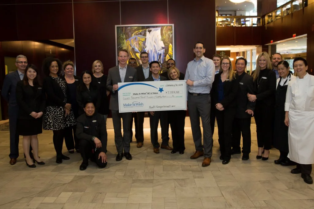 The Hyatt team presenting a cheque for $7,724.80 to the Make A Wish Foundation.