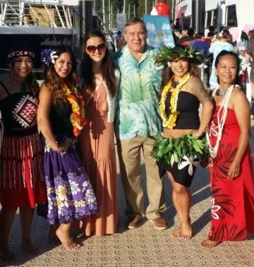 Randy Vannatter, president and CEO of City Passports, with a bevy of Hawaiian-themed attendees, boarding the Clefs d’Or charity boat cruise.