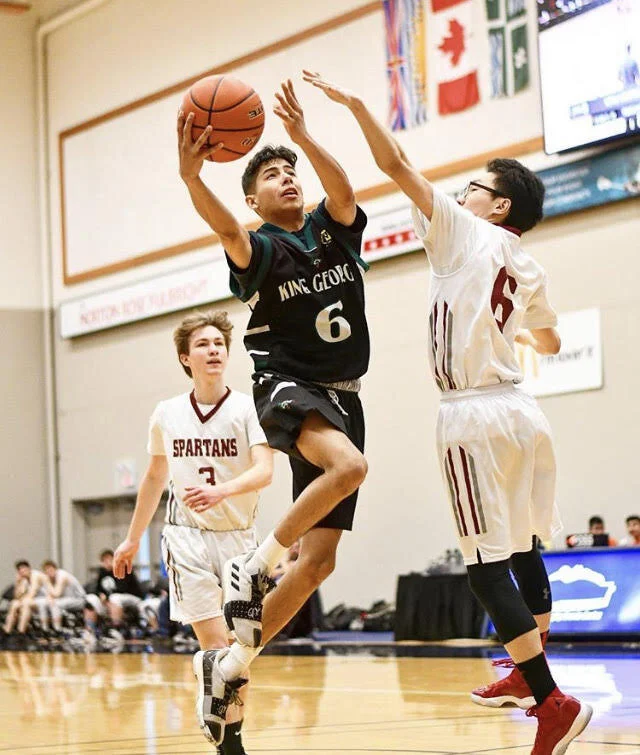 King George Dragons team member Alejandro evades Spartan players at a match at Windermere Secondary.