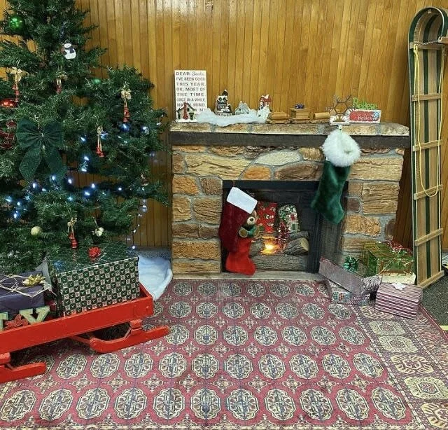 No cozy armchair this year — but a fireplace creates the holiday season mood.