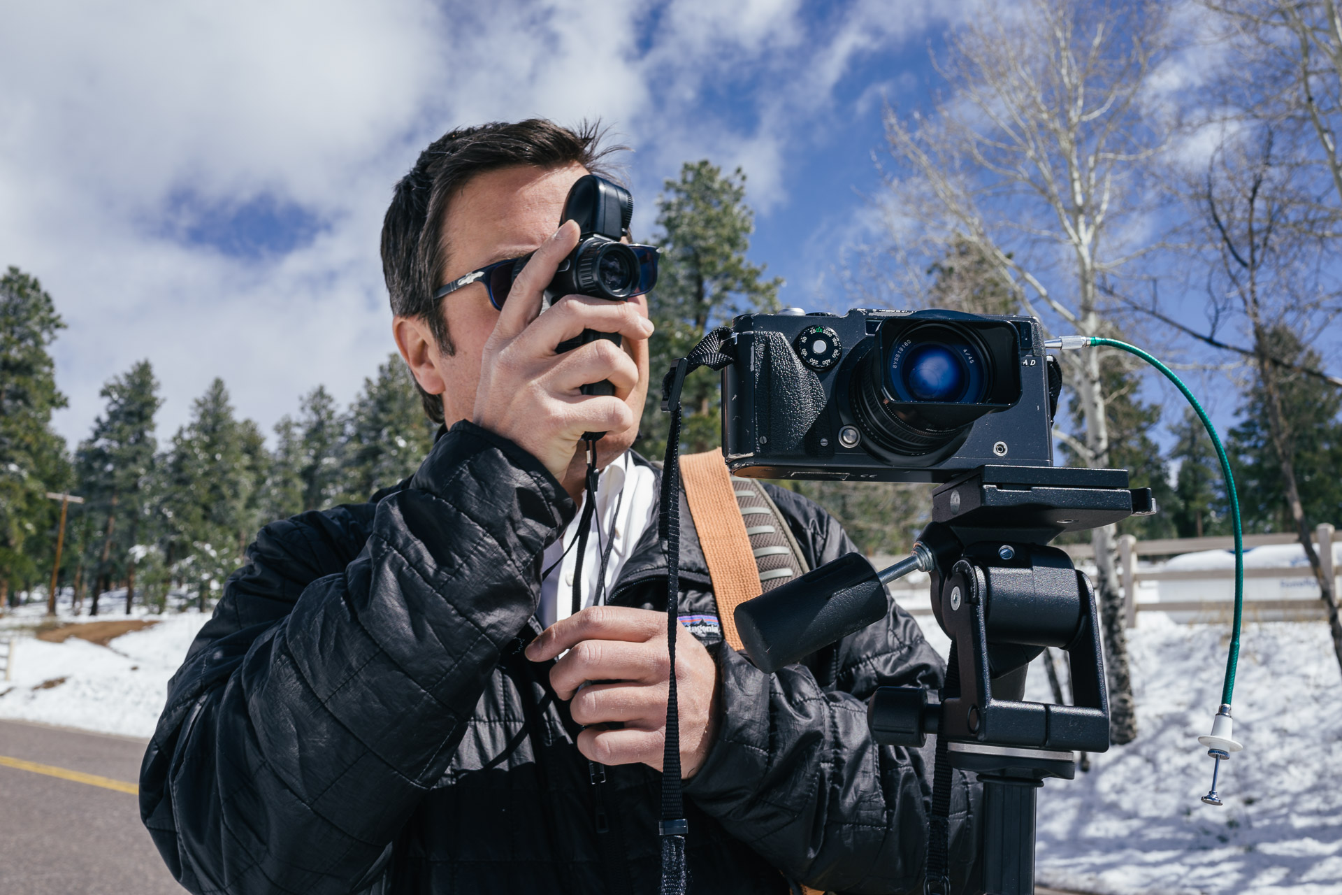 Joseph Gamble metering the scene before making a panoramic image with the Hasselblad Xpan film camera. Here he used the Zone System to meter for the snow and then opened the aperture 2.5 stops to achieve the exposure he wanted. May 11, 2015.
