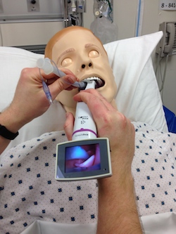 Center glottic opening on screen and pass the tube