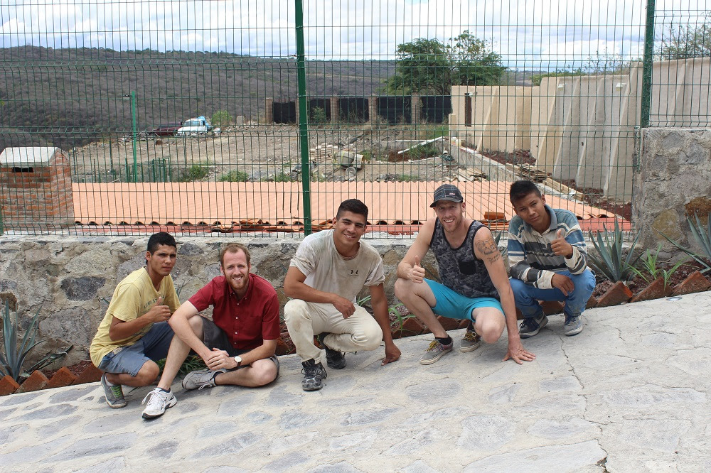 Three of our youth working hard in the construction, with directors Justin and Darren.