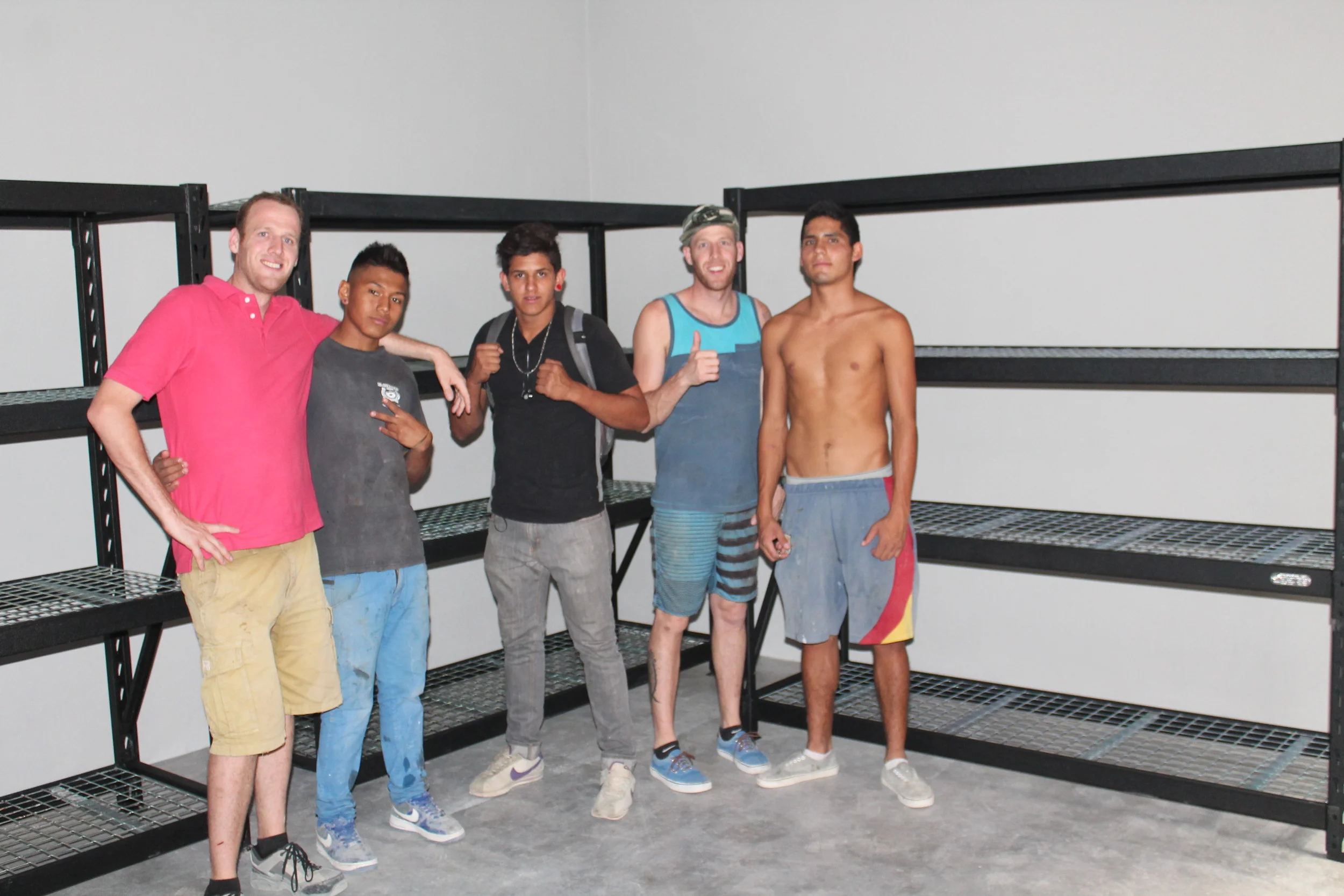 Three of our youth, Eduardo, Fernando, and Chino (from left to right), in the storage room.