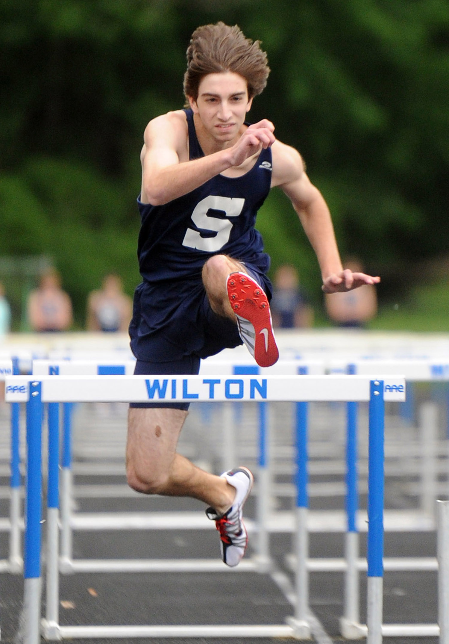  Todd Lubin jumps a hurdle during a track meet at Wilton High School on May 19, 2011. 