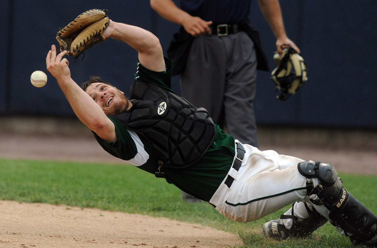 Norwalk's Kevin Daniele misses the ball as he leans backwards to try to catch it during Thursday's FCIAC semifinal game at the Arena at Harbor Yard on May 26, 2011.