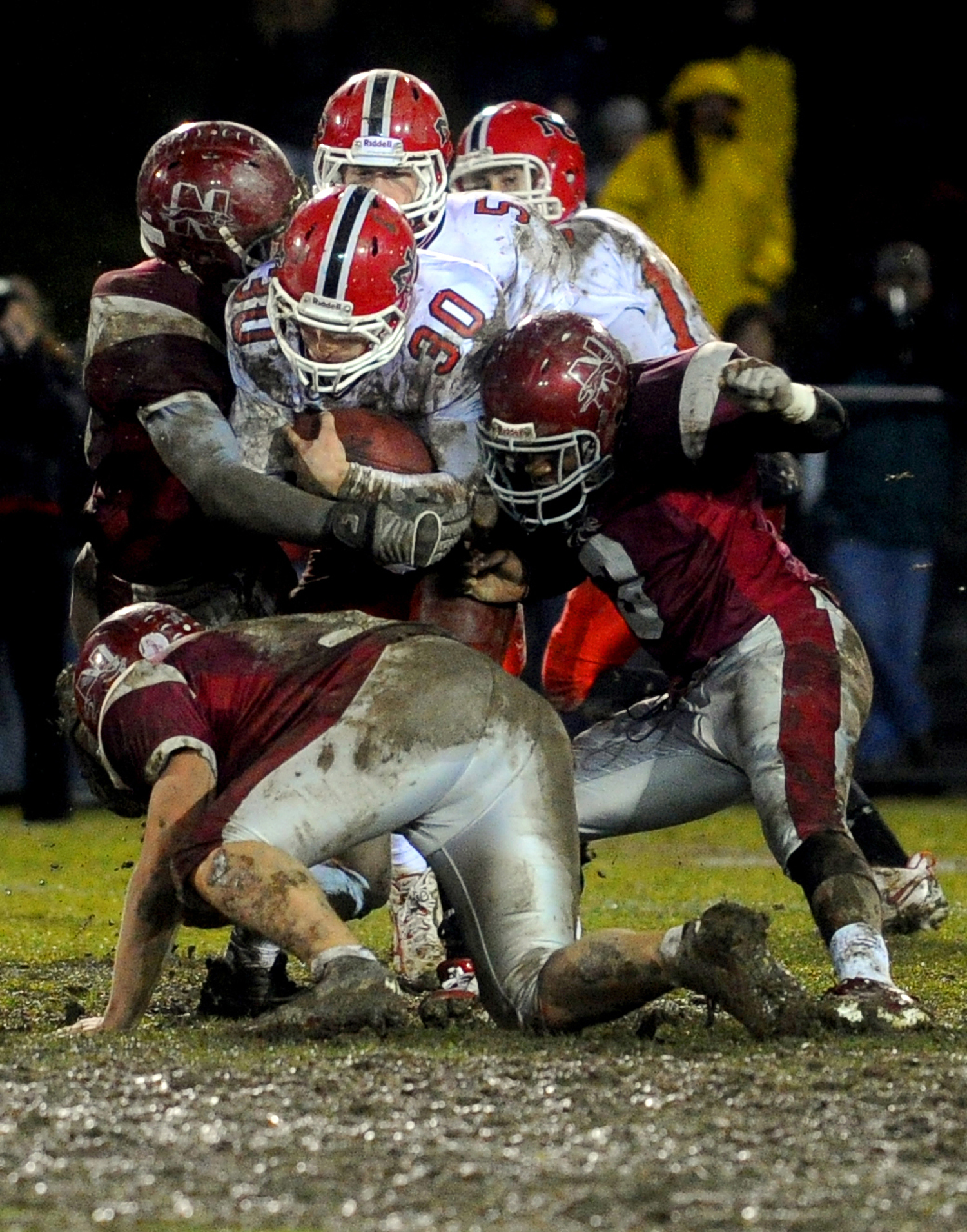  New Canaan's Conor Goodwin is tackled during Tuesday's Class L quarterfinal game at Naugatuck High School on November 30, 2010. 