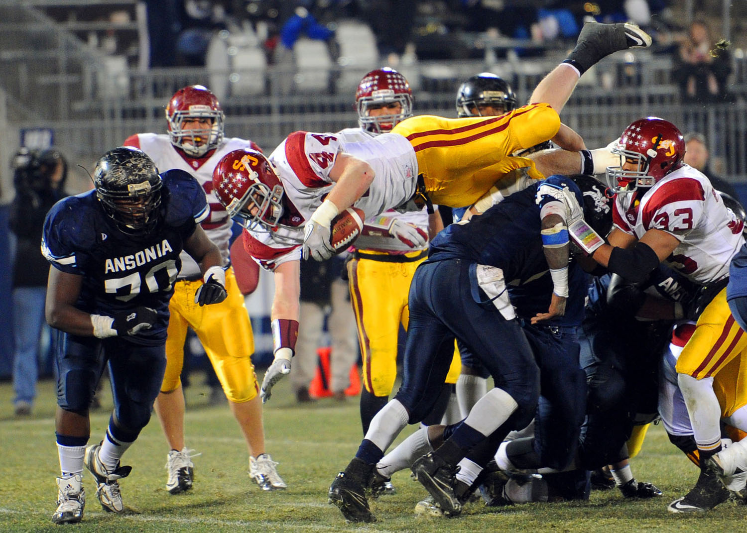  St. Joseph's Tyler Matakevich dives over Ansonia's defense to score a touchdown during the Class S State Football Championship game in East Hartford on December 11, 2010. 