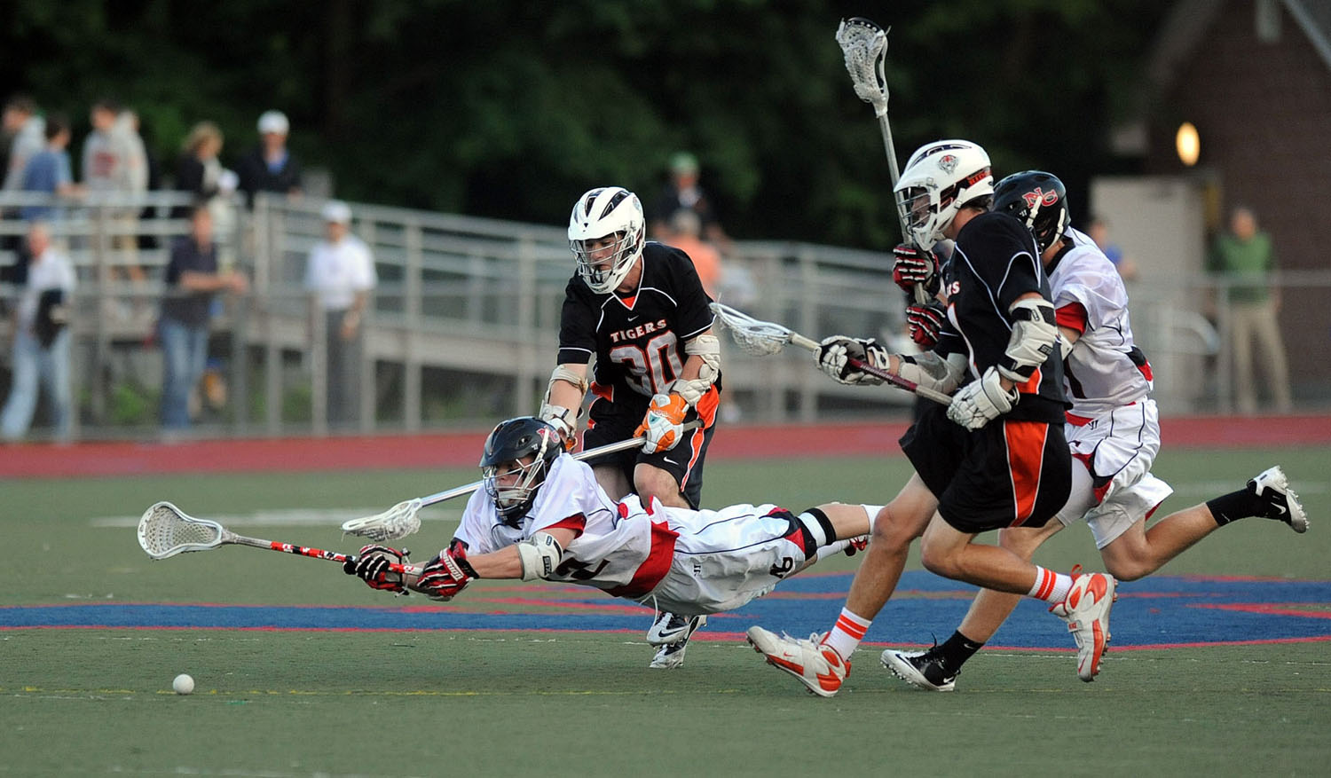  New Canaan's Robert Distler dives for the ball during Friday's FCIAC boys lacrosse championship game at Brien McMahon High School in Norwalk on May 25, 2012. 