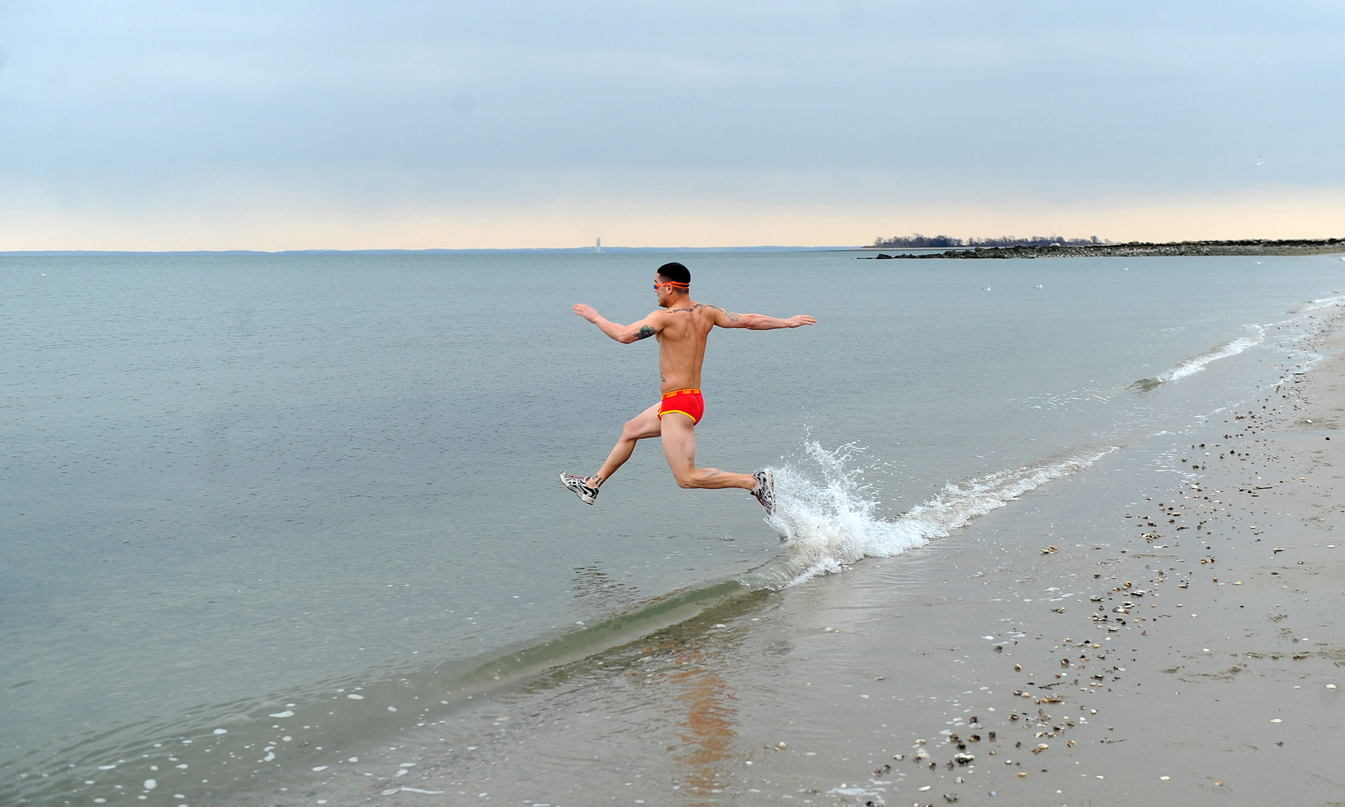  Ken Ildefonso is the first to run into the Long Island Sound at Compo Beach in Westport, Conn., during the Team Mossman Polar Plunge to benefit Save the Children, Tuesday morning, Jan. 1, 2013. 
