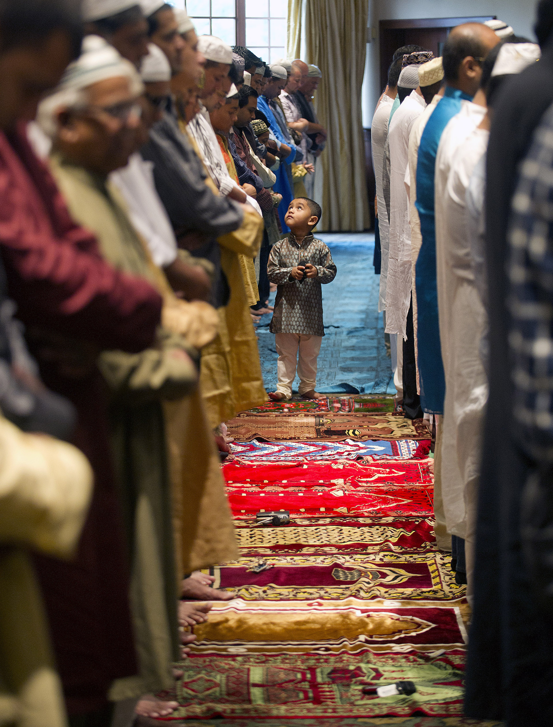  Members of the Stamford Islamic Center participate in Eid al-Fitr prayers to mark the end of Ramadan at the Italian Center in Stamford, Conn., on Thursday, August 8, 2013. 