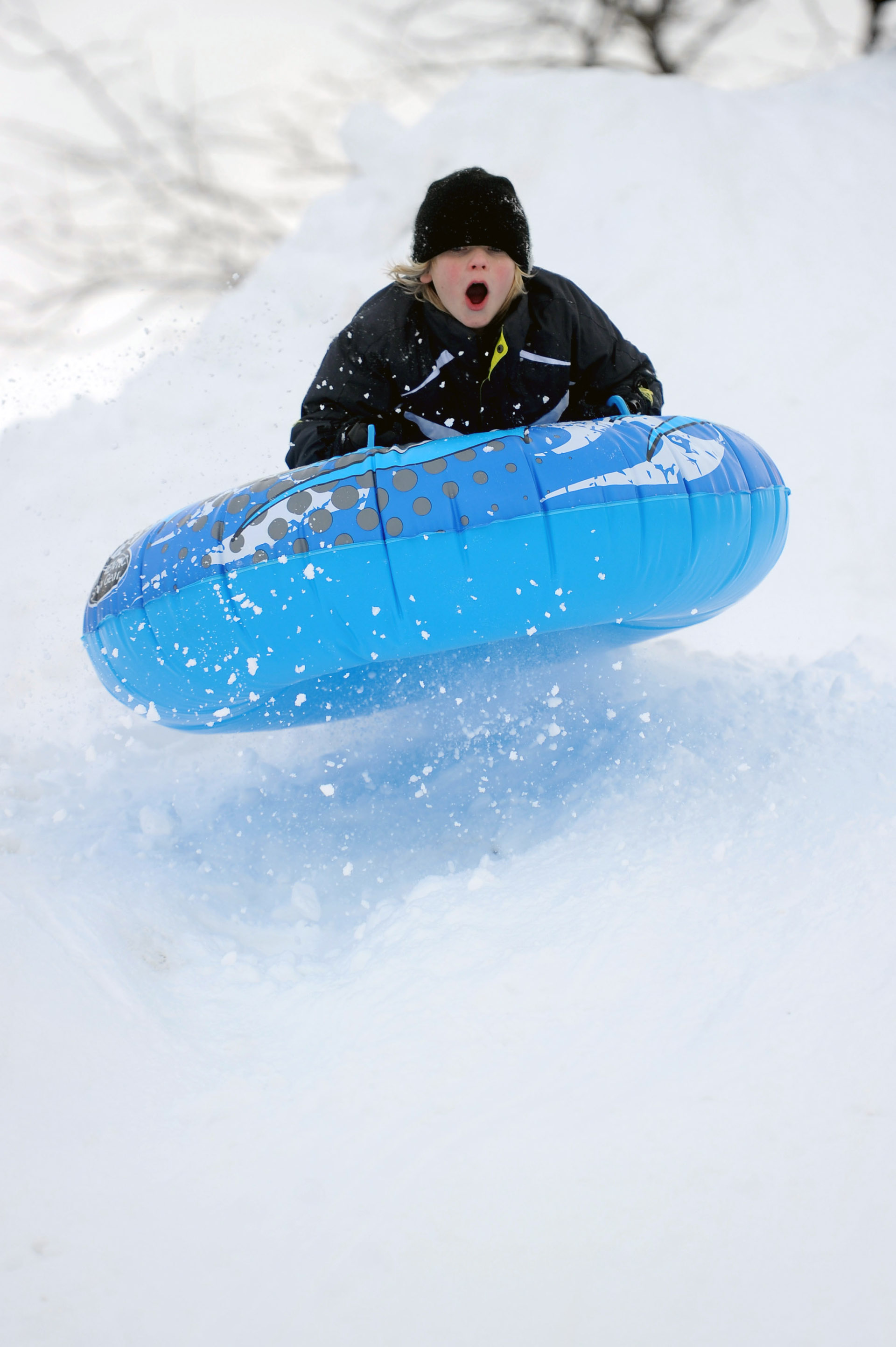 Christopher Puchala, 11, catches some air as he sleds off a giant mound of snow created by plows in Westport on Wednesday, January 12, 2011.