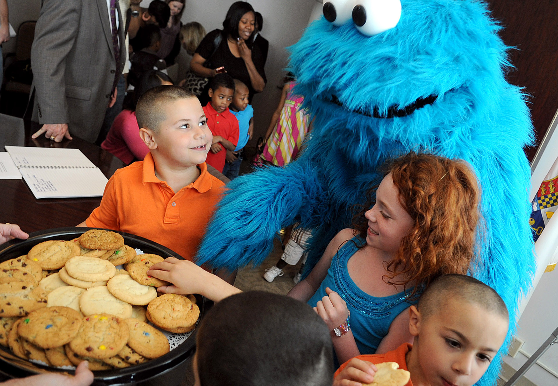 Cookie Monster reaches for a plate of cookies after Stamford Mayor Michael Pavia proclaimed April 17, 2012, "Sesame Street Live Day" in advance of three perfomances at The Palace Theatre.
