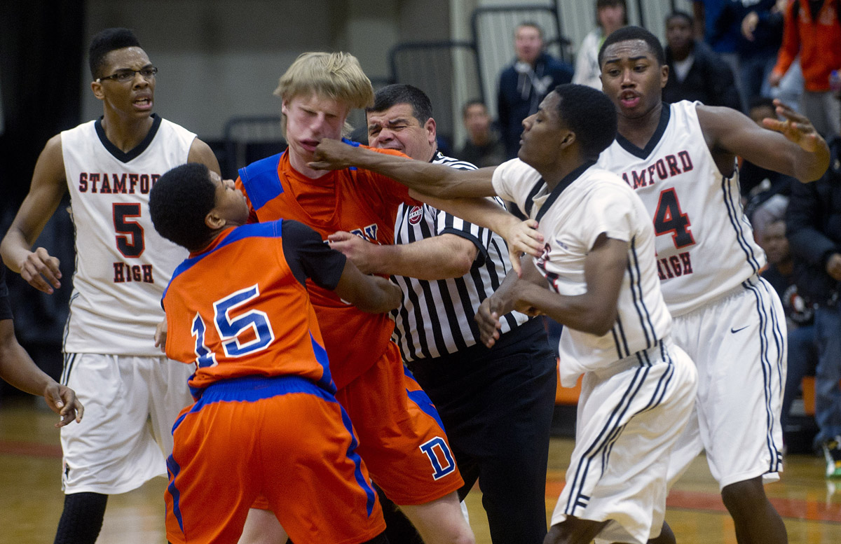 Danbury's Corey Brosz and Stamford's Ancel Nervers fight during Friday's basketball game at Stamford High School on January 17, 2014.