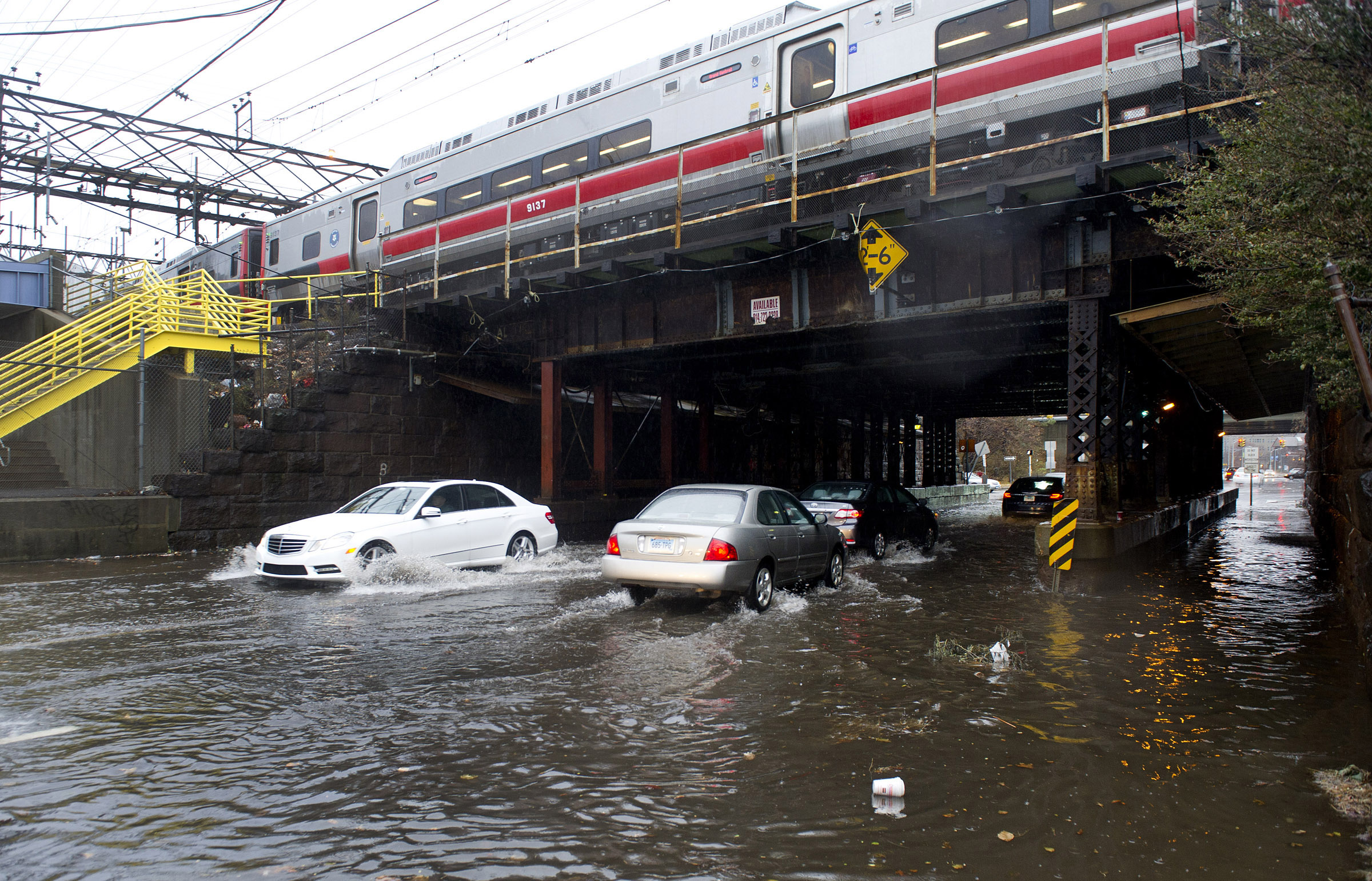 Drivers carefully maneuver through flooding on Elm Street in Stamford, Conn., during heavy rains due to a Nor'easter on Tuesday, December 9, 2014.