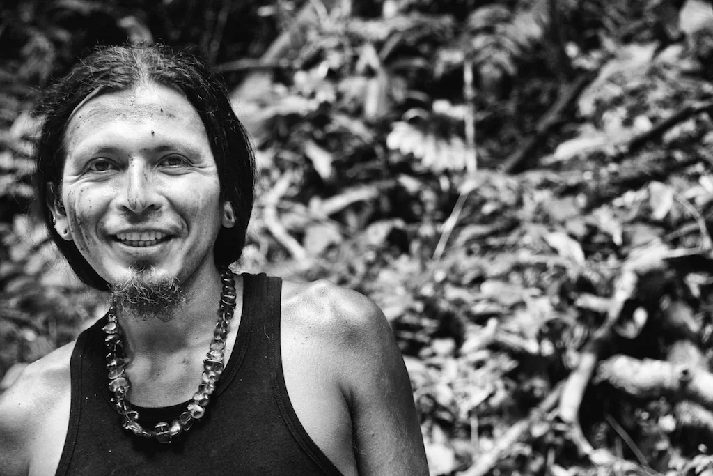 Juan Carlos smiles at a waterfall in the jungle