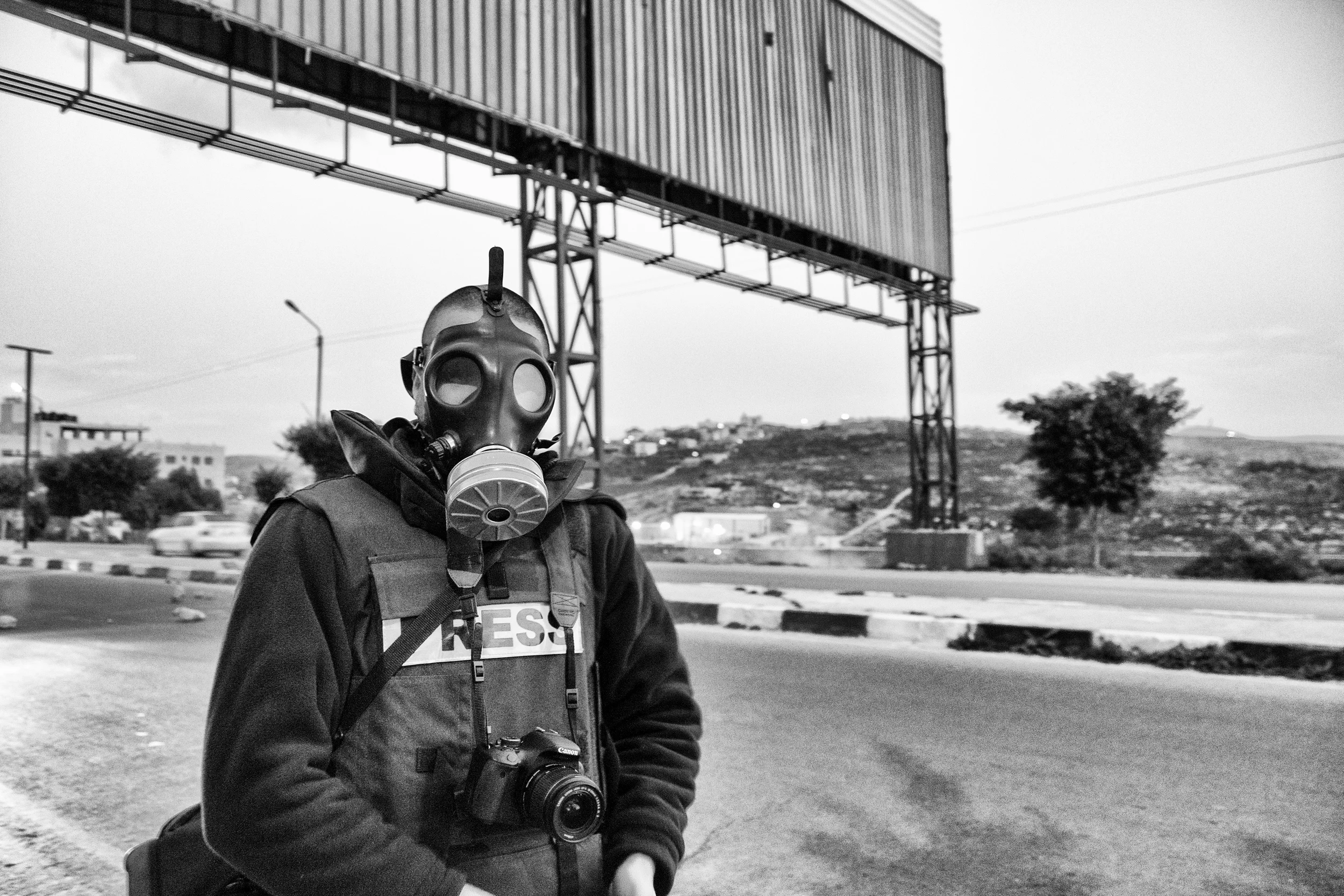 A member of the press prepares for a protest