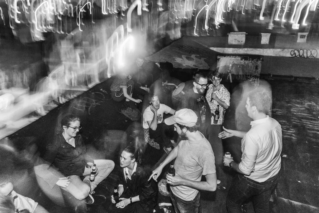 Members of Doubting Thomas Cruise Control hang out with friends on a rooftop in Clinton Hill, Brooklyn after a show 