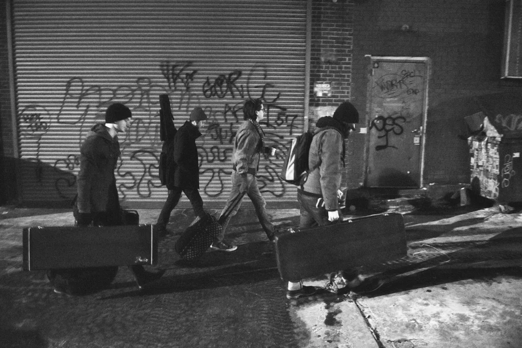 Doubting Thomas Cruise Control carries their instruments and gear to a venue in Bushwick, Brooklyn