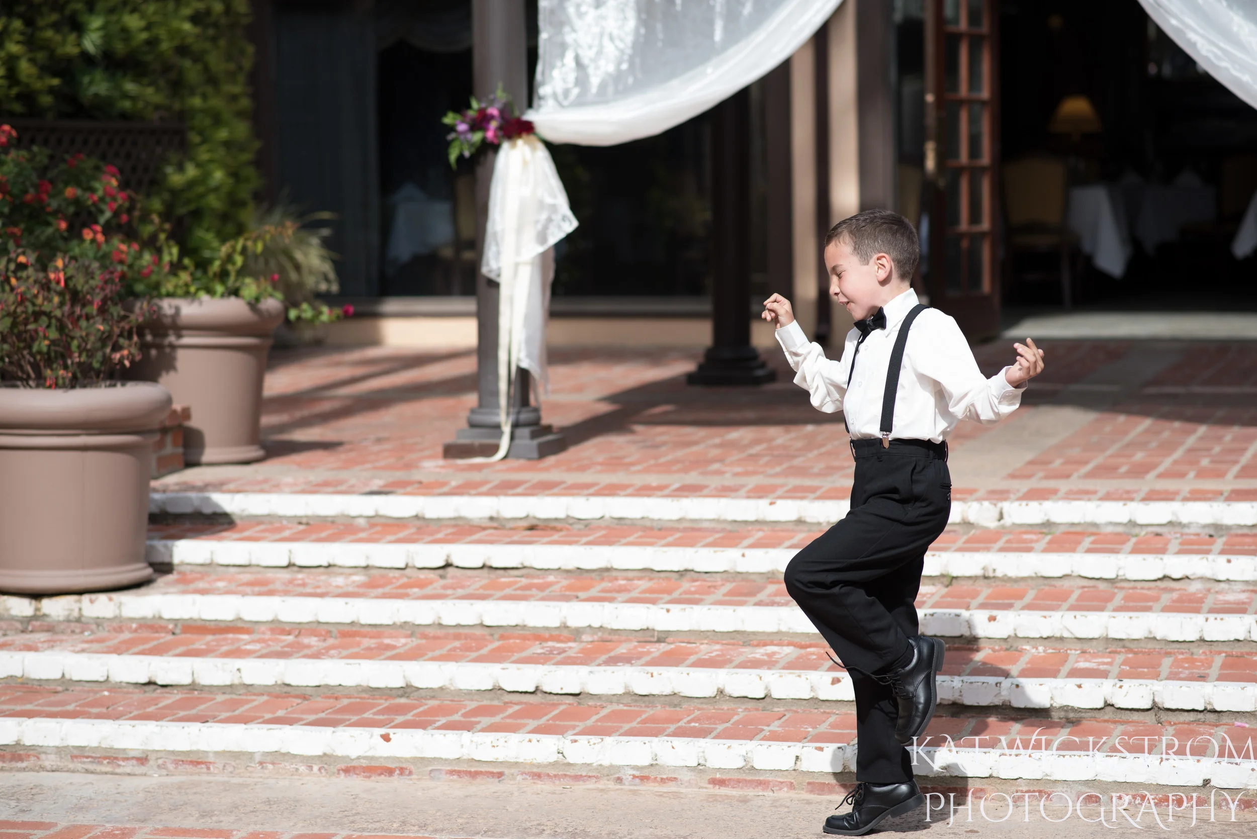 ring bearer dancing at wedding ceremony