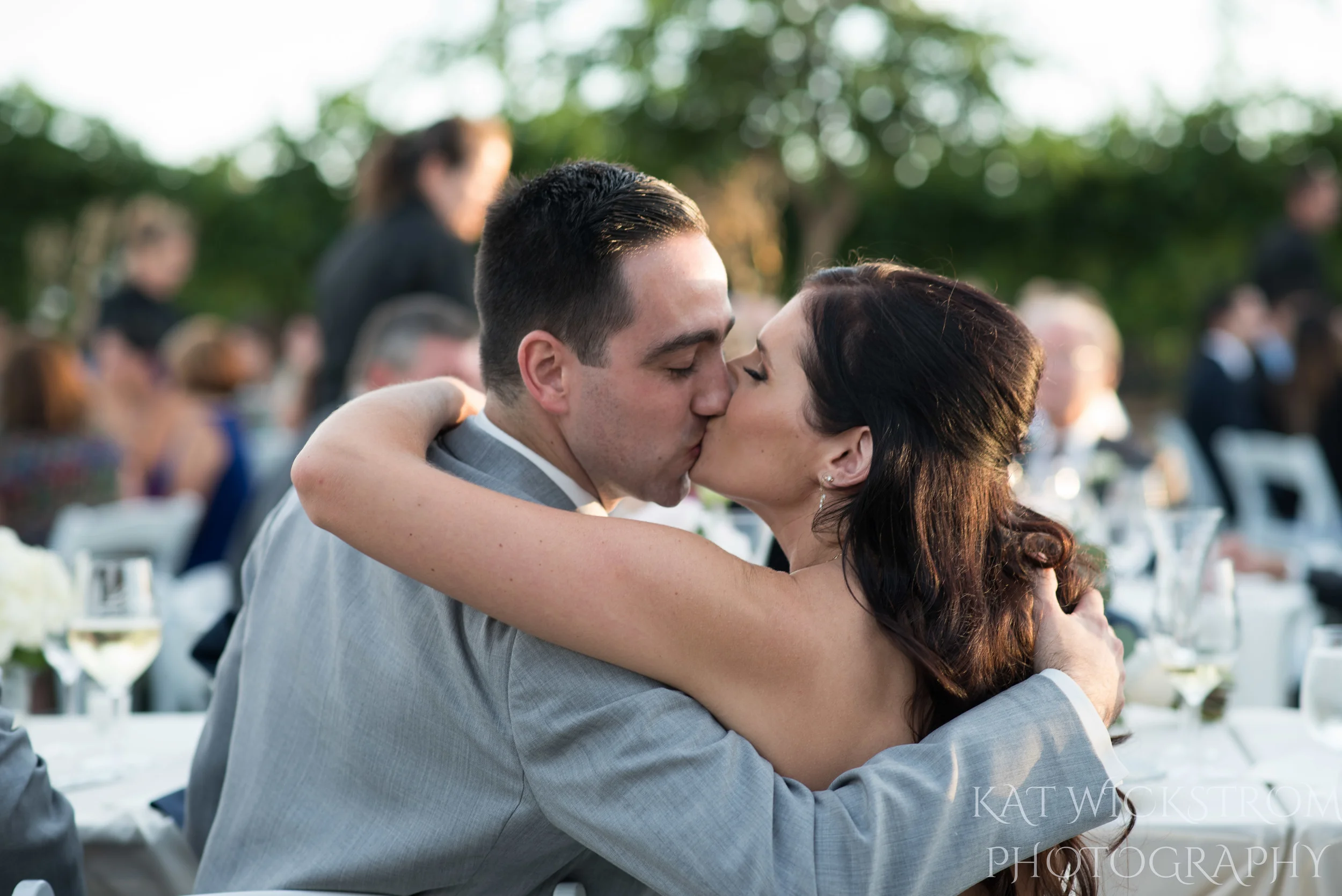 bride and groom kiss at reception