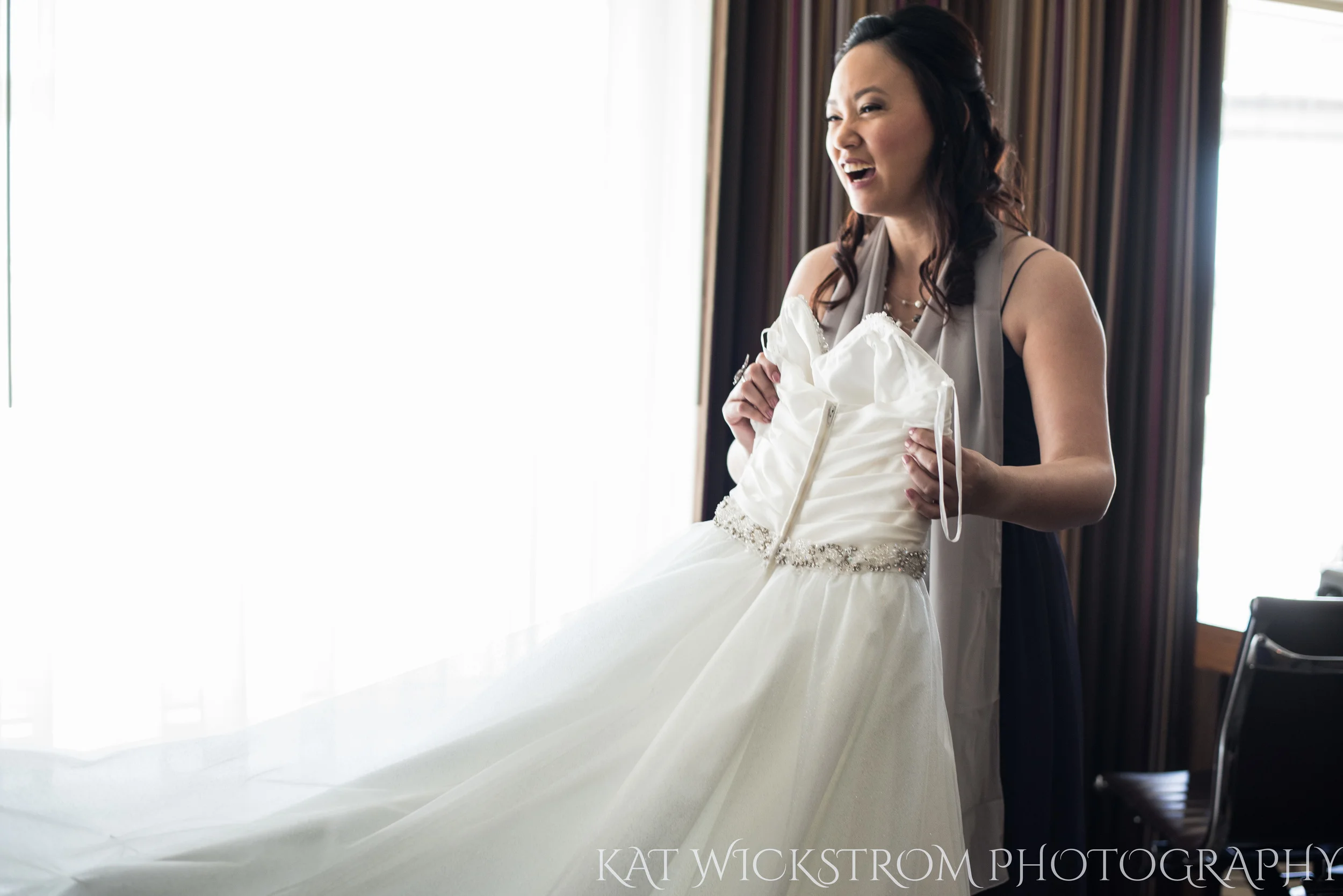 Bridesmaid helping get dress on