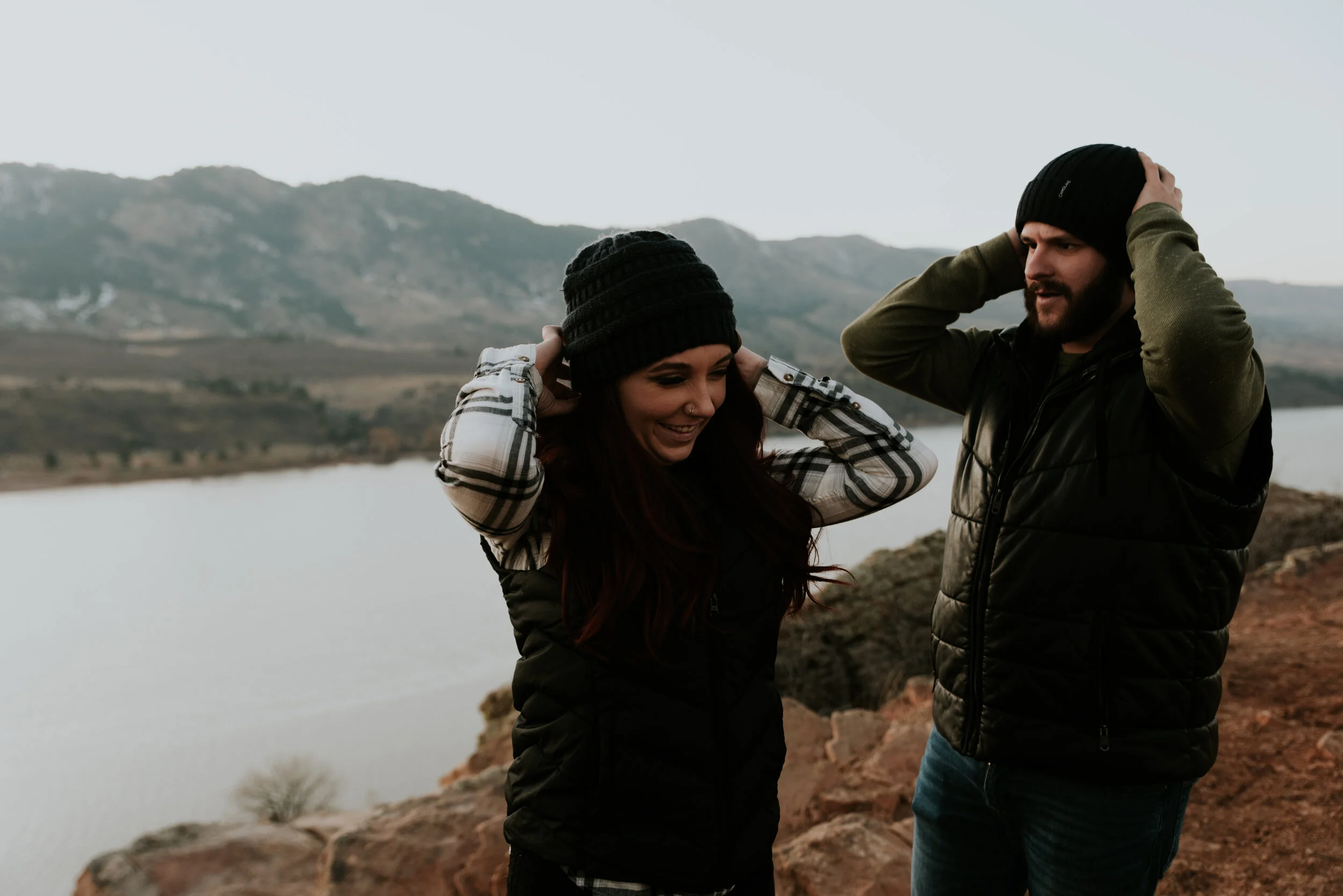 couple-puts-on-hats-during-engagement-session
