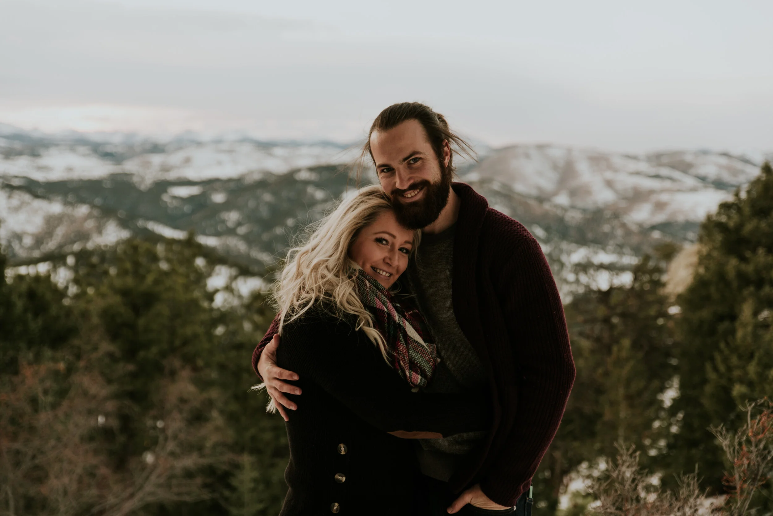 couple-embraces-in-mountain-engagement